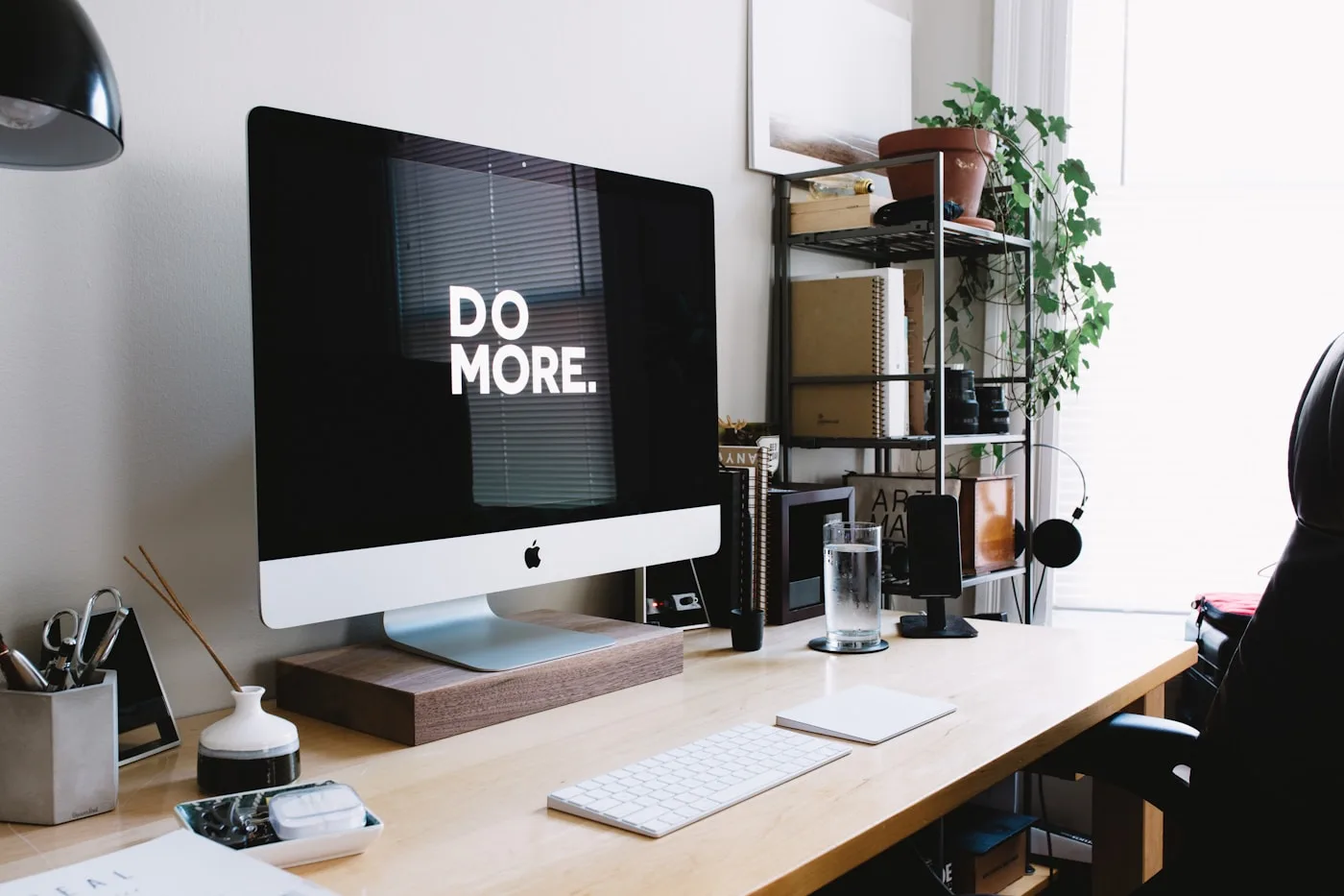 A quiet desk with a computer and everyday objects